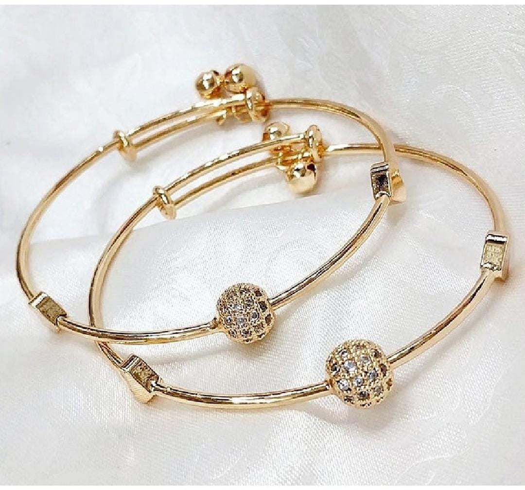 F991C2BA-81F2-4270-A894-1D24E1D92AD9 Pair of Adjustable Golden Bracelets - Image 1